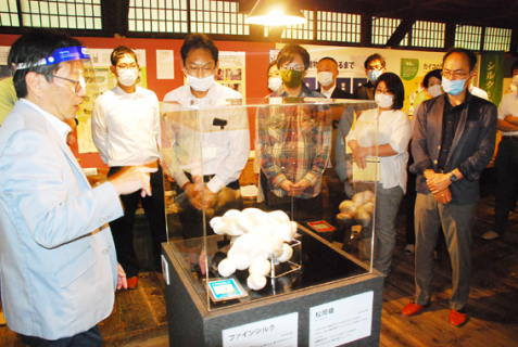 松ケ岡開墾記念館で塾生たちに鶴岡の絹産業の歴史を解説した大和さん（左）