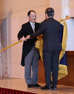 高橋県教育長が遠田校長（左）に校旗を授与