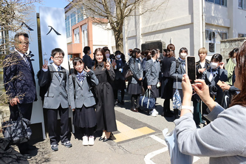 中学と高校2つの「入学式」の看板が立ち、記念撮影する親子の列が続いた＝致道館高正門