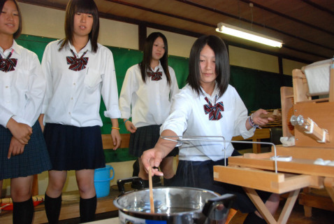 繭から糸を取り出す「ざぐり」の作業に挑戦する鶴岡中央高の生徒たち